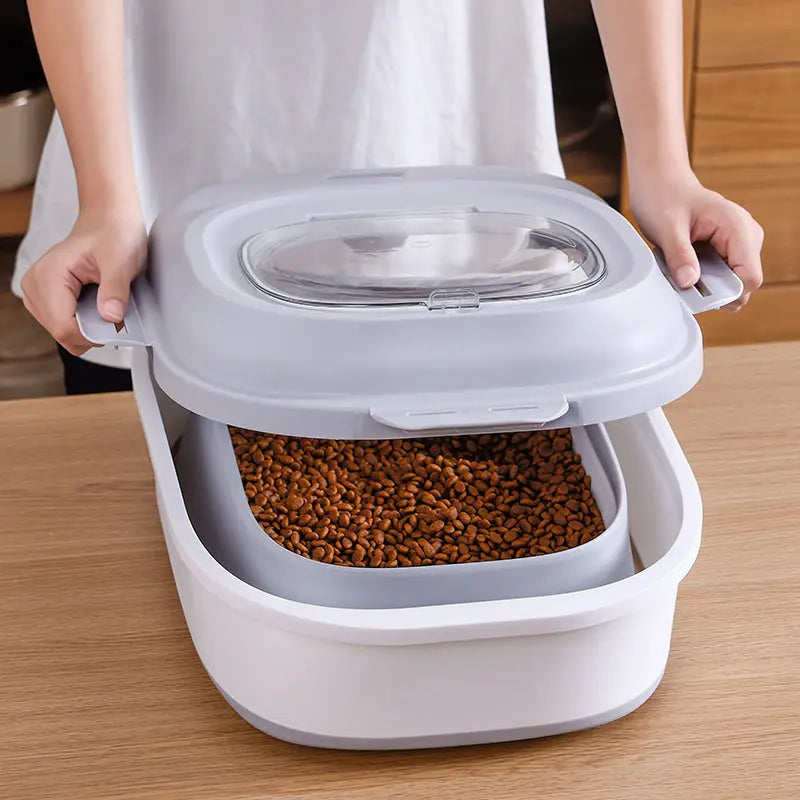 Locking top lid lifted from kibble-filled collapsible pet food storage bin