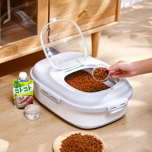 Folded grey pet food storage bin with clear access hatch and kibble scoop